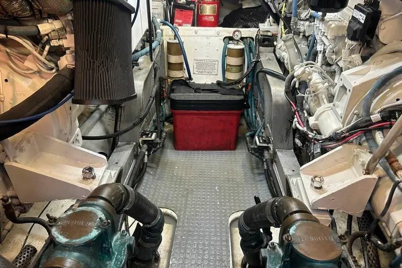 Slide: The Image of Engine room of a 1995 Bertram 43 Convertible boat, showcasing mechanical components and wiring. - 22