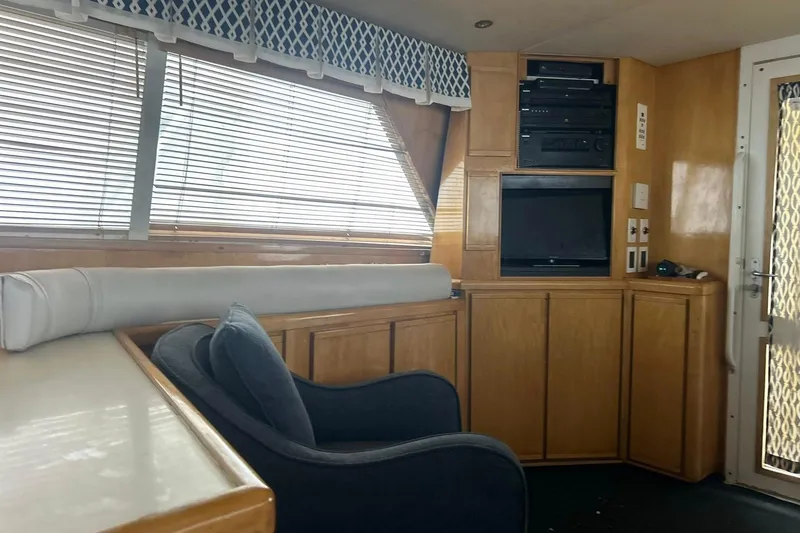 Slide: The Image of Interior of a 1995 Bertram 43 Convertible yacht with wood paneling and entertainment system. - 6