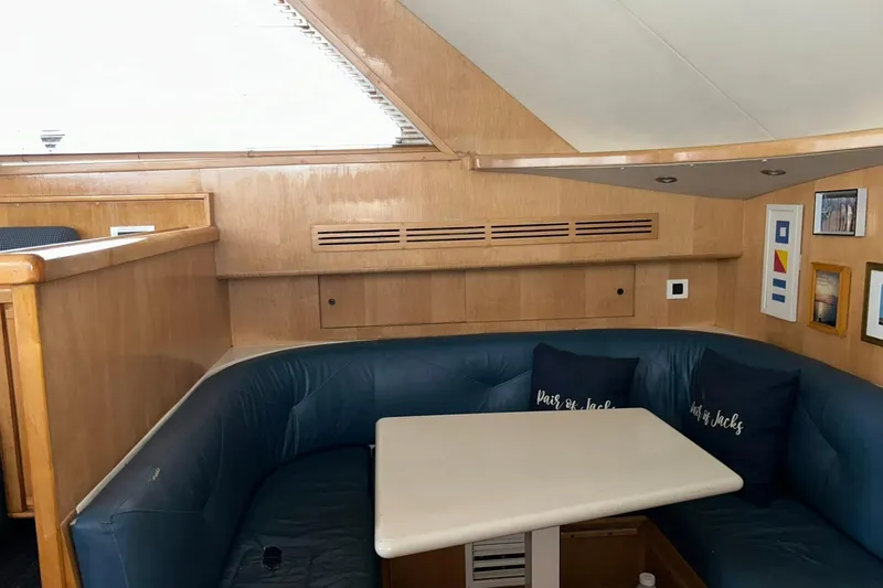 Slide: The Image of Interior of a 1995 Bertram 43 Convertible yacht with blue seating and wooden accents. - 9