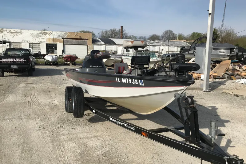Slide: The Image of 2001 Ranger 217B Cherokee boat on trailer in outdoor storage area. - 11