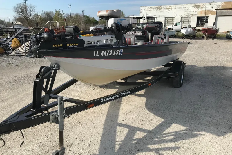 Slide: The Image of 2001 Ranger 217B Cherokee boat on trailer in outdoor setting. - 12