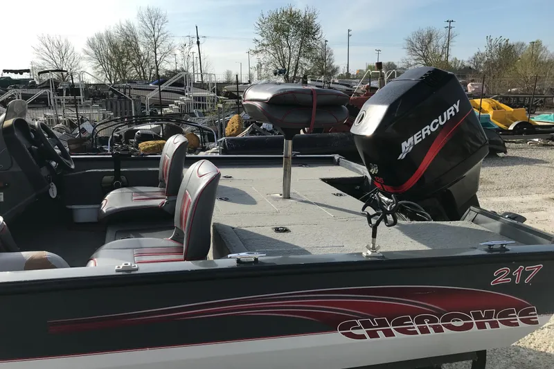 Slide: The Image of 2001 Ranger 217B Cherokee boat with Mercury engine, parked outdoors. - 14