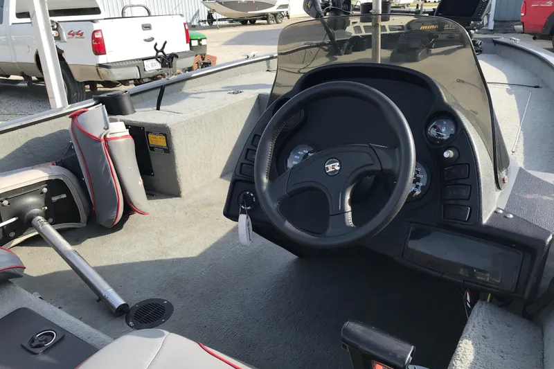 Slide: The Image of Interior view of a 2001 Ranger 217B Cherokee boat cockpit with steering wheel and gauges. - 18