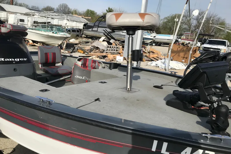 Slide: The Image of 2001 Ranger 217B Cherokee boat with seating and equipment, parked outdoors. - 22