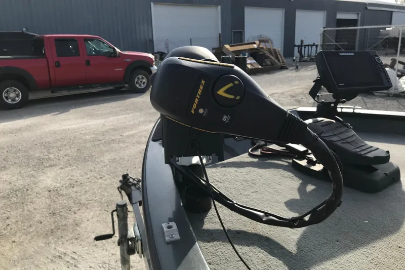 Slide: The Image of Trolling motor on 2001 Ranger 217B Cherokee boat, with red truck in background. - 24