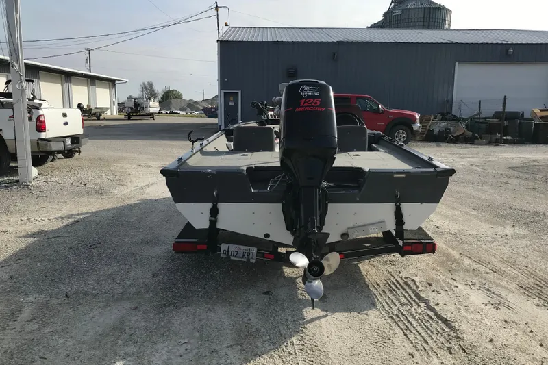 Slide: The Image of 2001 Ranger 217B Cherokee boat with Mercury 125 engine, parked outdoors. - 5