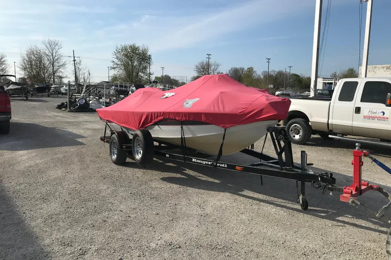 Slide: The Image of 2001 Ranger 217B Cherokee boat on trailer with red cover in outdoor lot. - 8