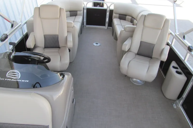 Slide: The Image of 2022 Sun Tracker Party Barge 22 DLX interior with plush seating and steering console. - 11