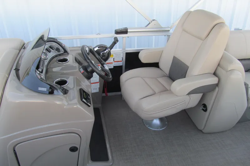 Slide: The Image of 2022 Sun Tracker Party Barge 22 DLX helm with comfortable captain's chair and steering console. - 13