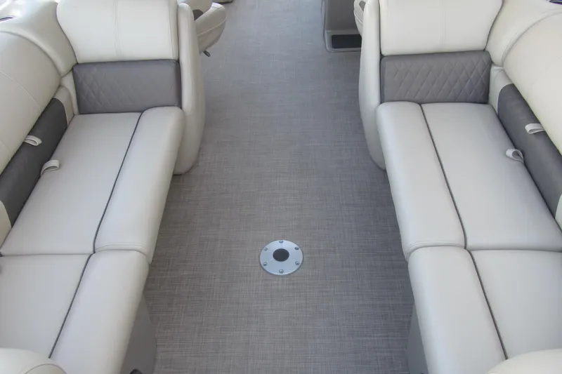 Slide: The Image of 2022 Sun Tracker Party Barge 22 DLX interior with plush seating and modern flooring. - 6