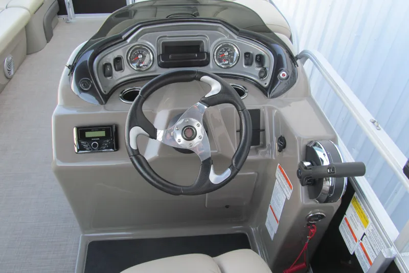 Slide: The Image of 2022 Sun Tracker Party Barge 22 DLX steering console with gauges and controls. - 7