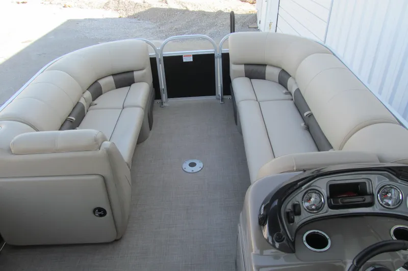 Slide: The Image of 2022 Sun Tracker Party Barge 22 DLX interior with beige seating and control panel. - 8