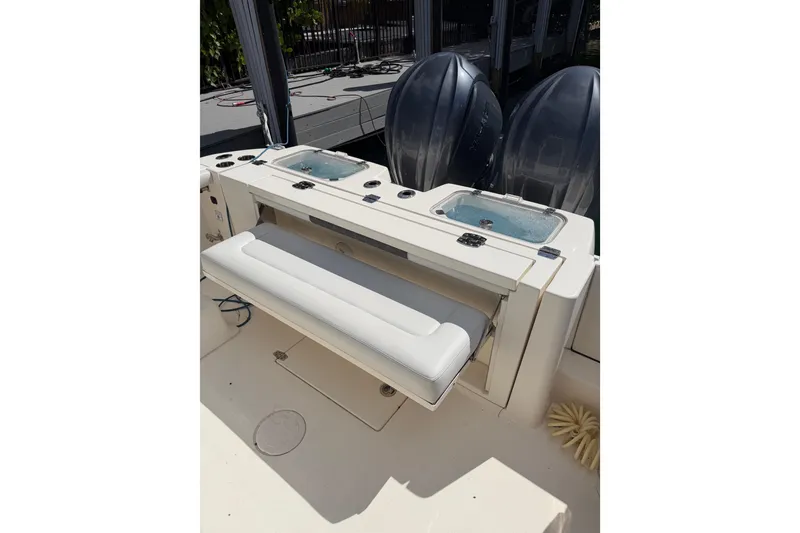 Slide: The Image of 2022 Cobia 320 Center Console boat with dual engines and seating area. - 5