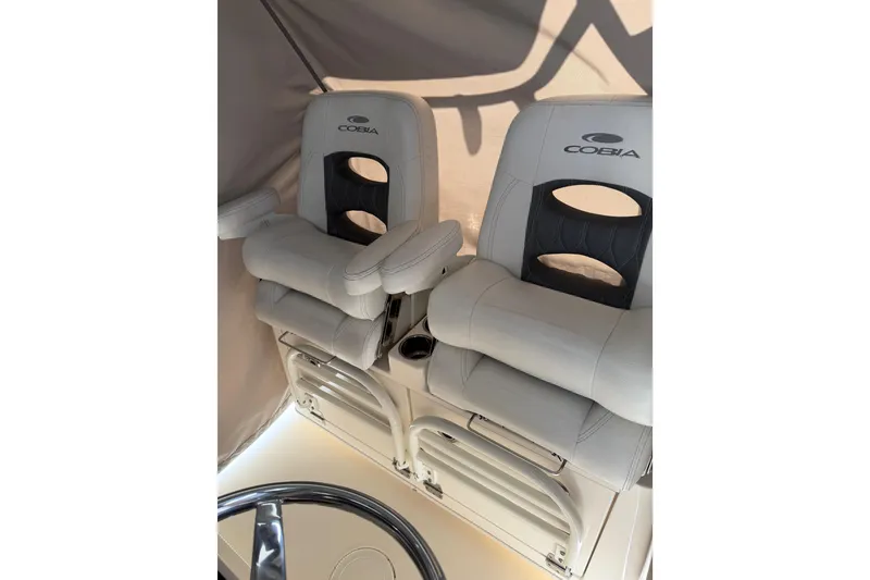 Slide: The Image of 2022 Cobia 320 Center Console boat seats with armrests and cup holders. - 7