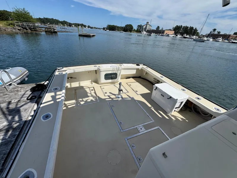 Slide: The Image of Spacious deck of a 2009 Northern Bay 36 boat docked by a serene waterfront. - 14