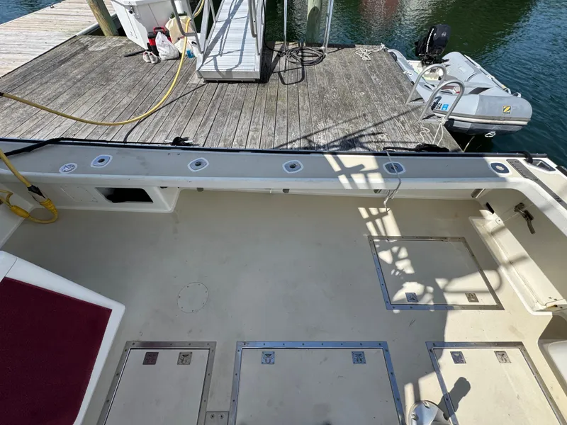 Slide: The Image of Northern Bay 36 boat deck, 2009 model, docked with visible storage compartments and equipment. - 19