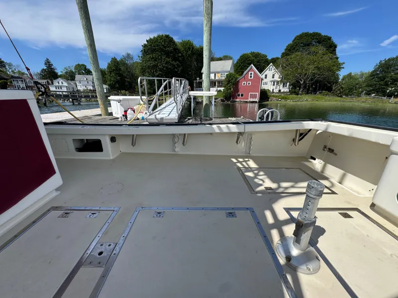 Slide: The Image of Northern Bay 36 boat deck, 2009 model, docked by scenic waterfront homes. - 21