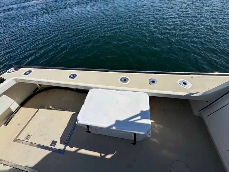 Slide: The Image of 2009 Northern Bay 36 boat deck with cooler, overlooking calm water. - 22