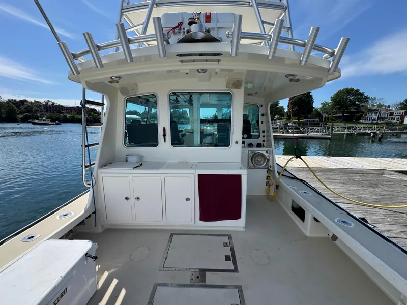 Slide: The Image of 2009 Northern Bay 36 boat docked, featuring spacious deck and cabin area. - 26