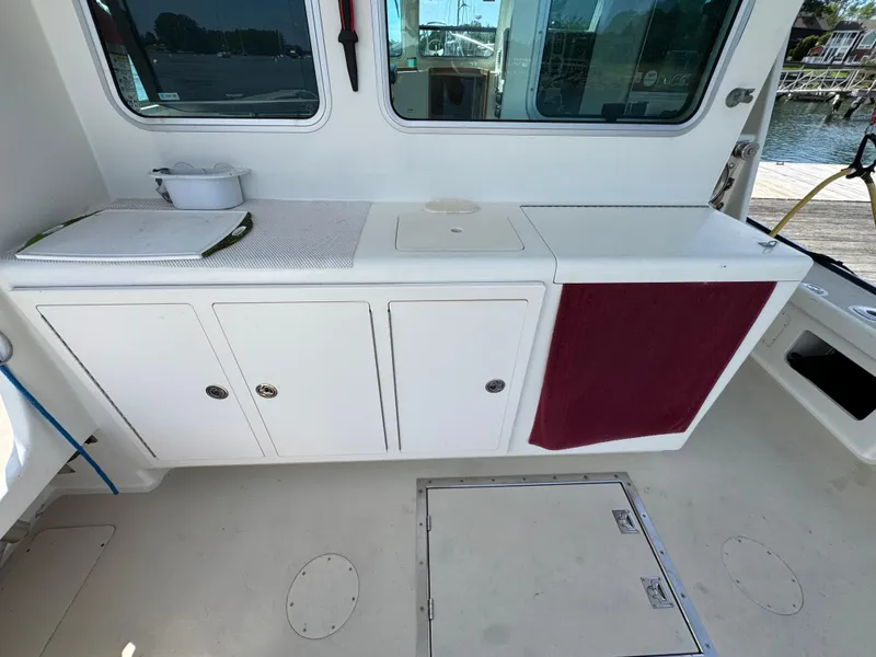 Slide: The Image of Interior view of a 2009 Northern Bay 36 boat, featuring a clean white counter and storage. - 28