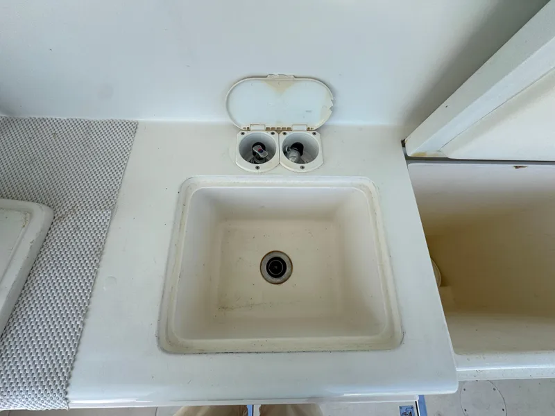 Slide: The Image of White sink and storage area on a 2009 Northern Bay 36 boat. - 30