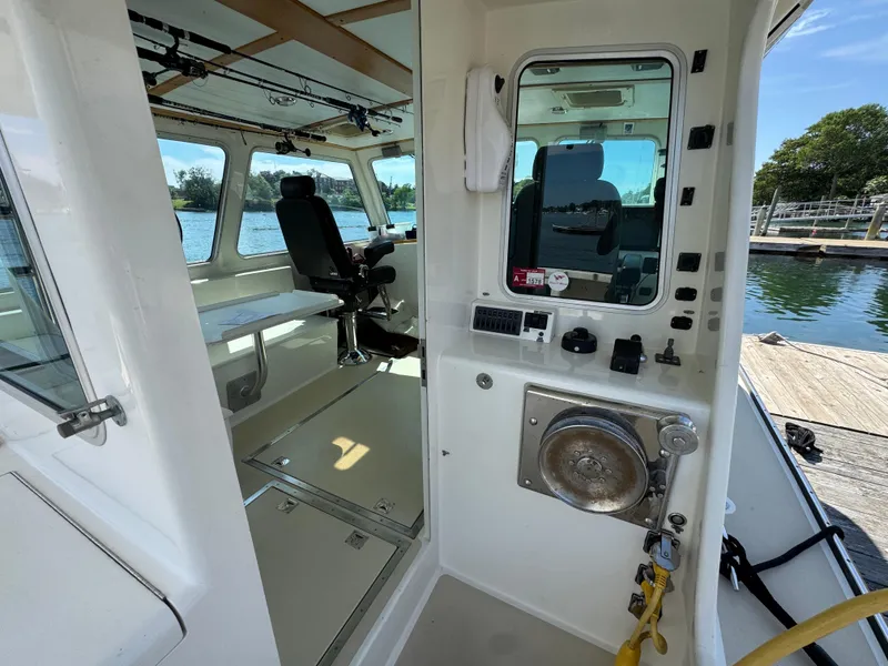 Slide: The Image of Interior view of a 2009 Northern Bay 36 boat, showcasing helm and seating area. - 33