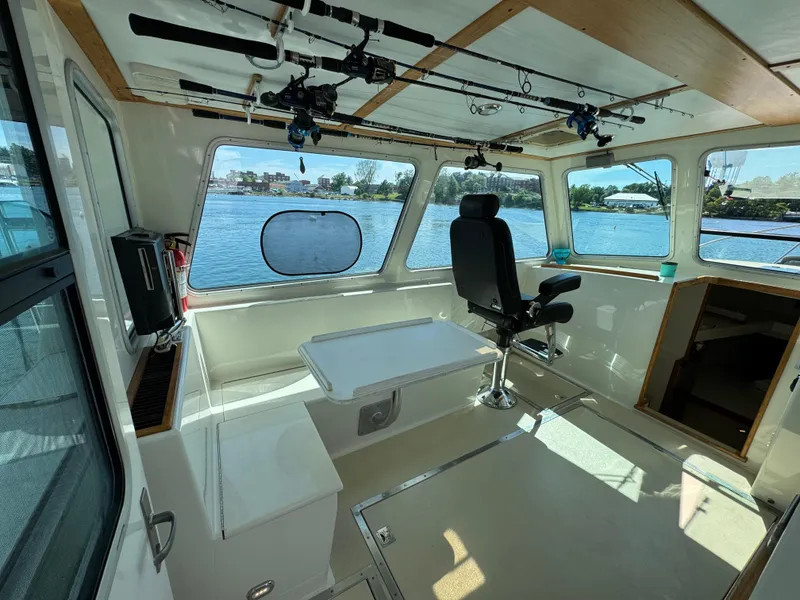 Slide: The Image of Interior of 2009 Northern Bay 36 boat with fishing rods and scenic water view. - 39