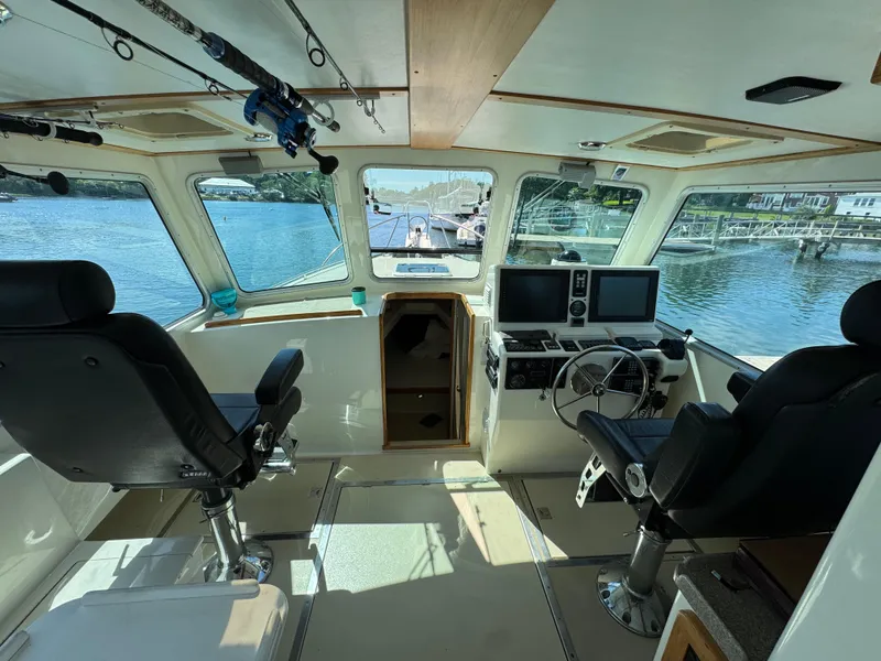 Slide: The Image of Interior of 2009 Northern Bay 36 boat with steering wheel, seats, and navigation equipment. - 40