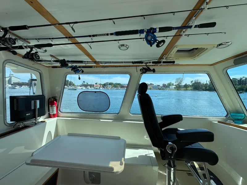 Slide: The Image of Interior of 2009 Northern Bay 36 boat with fishing rods and scenic water view. - 43