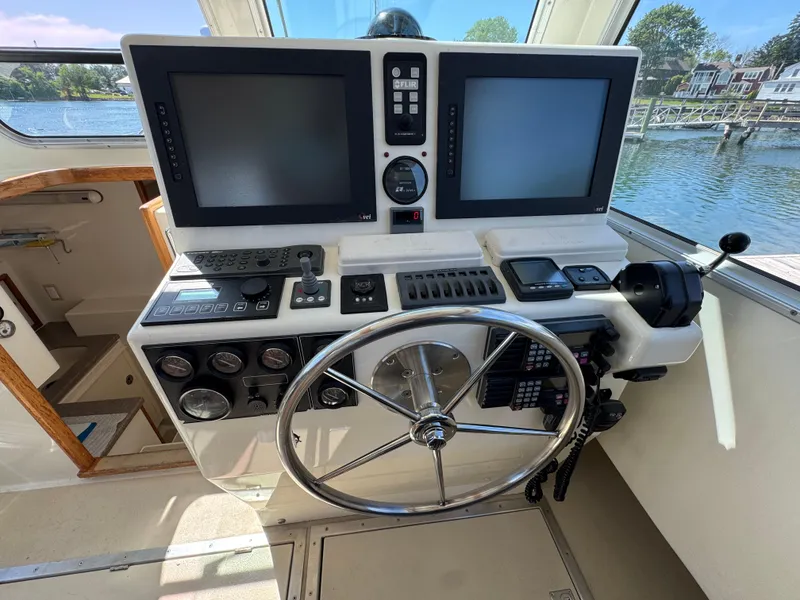 Slide: The Image of Helm of 2009 Northern Bay 36 boat with dual screens and navigation controls. - 48