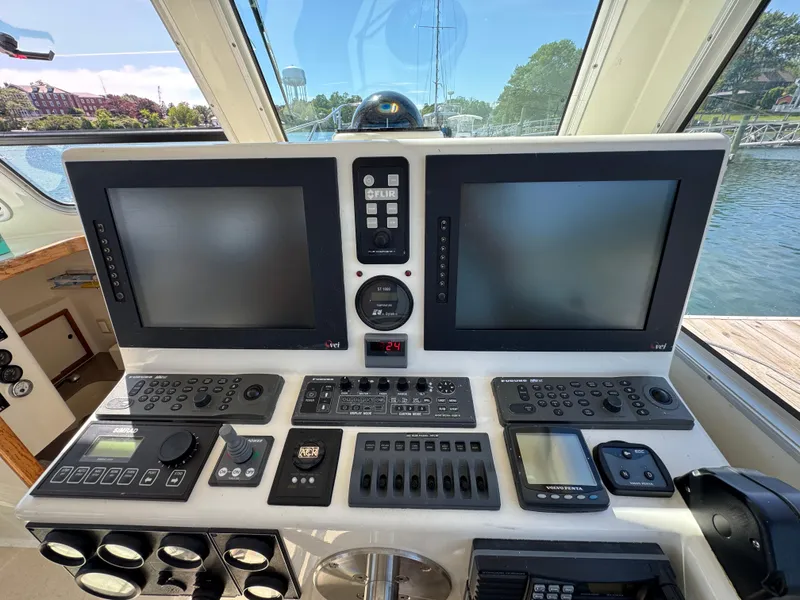 Slide: The Image of Control panel of a 2009 Northern Bay 36 boat with navigation screens and instruments. - 49