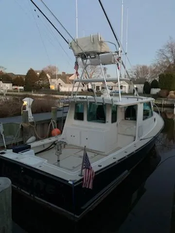 Slide: The Image of 2009 Northern Bay 36 boat docked, featuring a spacious deck and fishing equipment. - 7