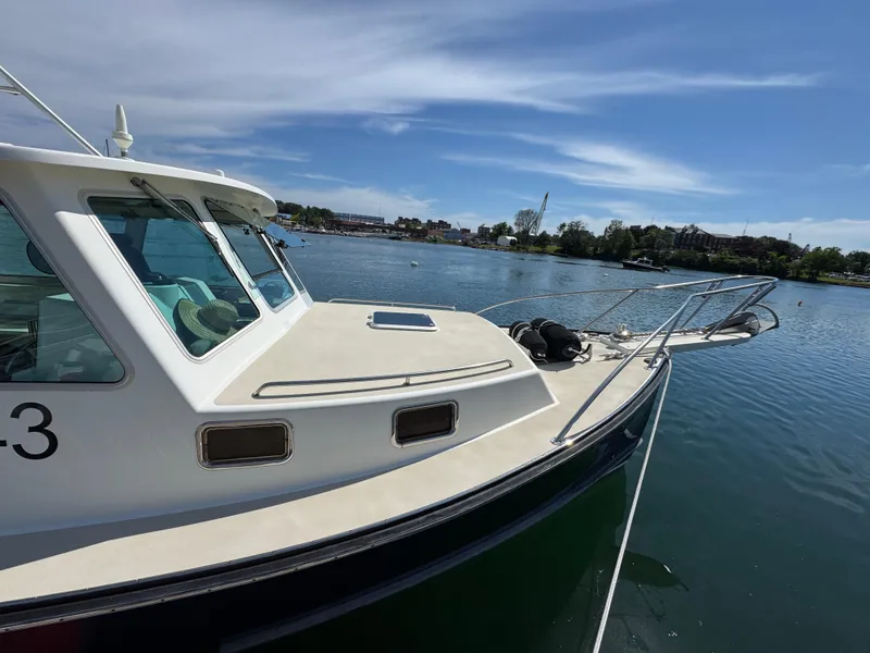 Slide: The Image of 2009 Northern Bay 36 boat docked on a sunny day with scenic waterfront view. - 9