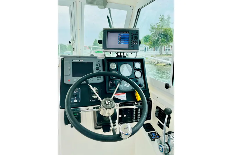 Slide: The Image of Helm of 2002 Albin 28 Tournament Express with navigation equipment and steering wheel. - 6