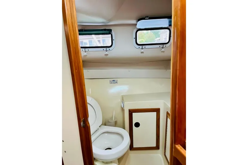 Slide: The Image of Bathroom interior of 2002 Albin 28 Tournament Express boat with wooden accents. - 8