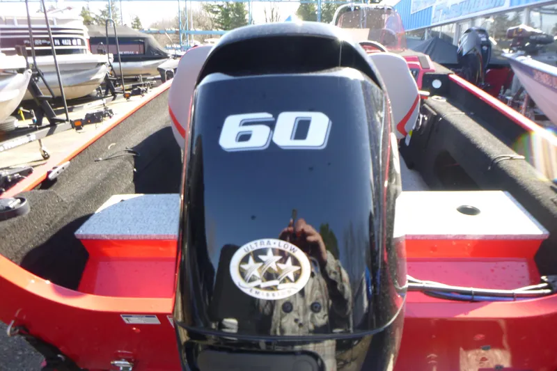 Slide: The Image of 2025 Smoker Craft Lazer 161 boat with 60 HP engine, parked outdoors. - 10