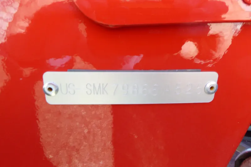 Slide: The Image of 2025 Smoker Craft Lazer 161 boat identification plate on red hull. - 11