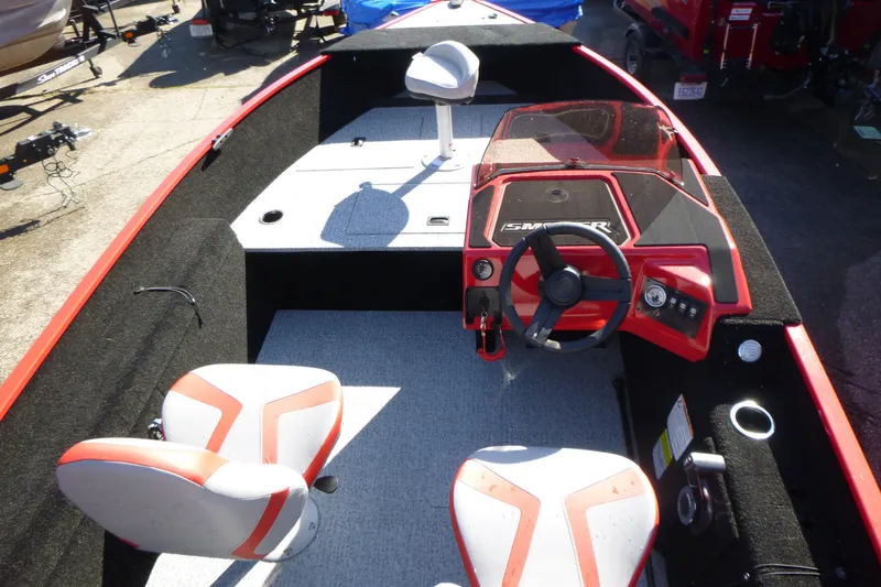 Slide: The Image of 2025 Smoker Craft Lazer 161 boat interior with red accents and dual seating. - 4