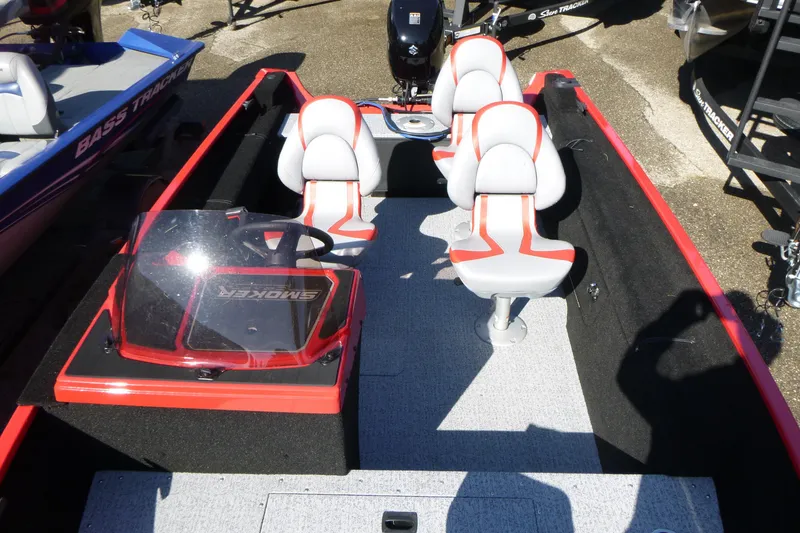 Slide: The Image of 2025 Smoker Craft Lazer 161 boat interior with red accents and seating. - 5