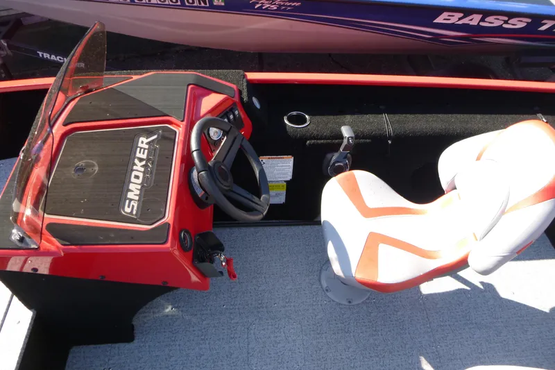 Slide: The Image of 2025 Smoker Craft Lazer 161 boat interior with steering wheel and seat. - 7