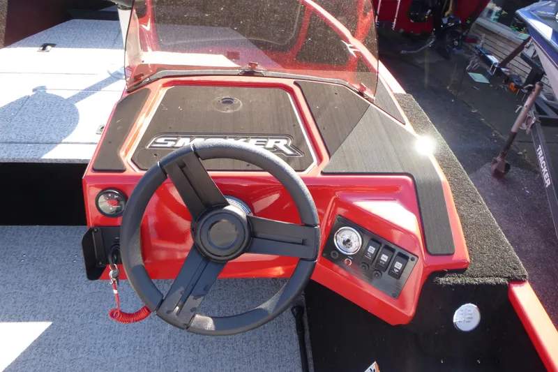 Slide: The Image of 2025 Smoker Craft Lazer 161 boat dashboard with steering wheel and control panel. - 8