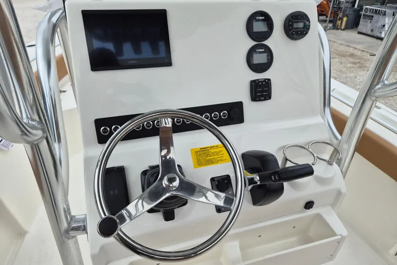 Slide: The Image of 2026 Key West 219 FS boat dashboard with steering wheel and control panel. - 10