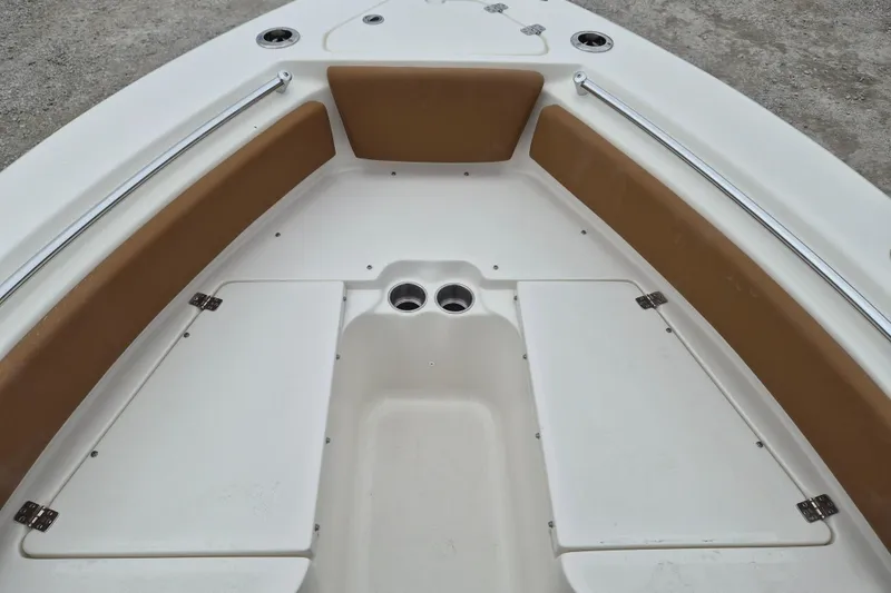 Slide: The Image of 2026 Key West 219 FS boat interior with cushioned seating and storage compartments. - 14