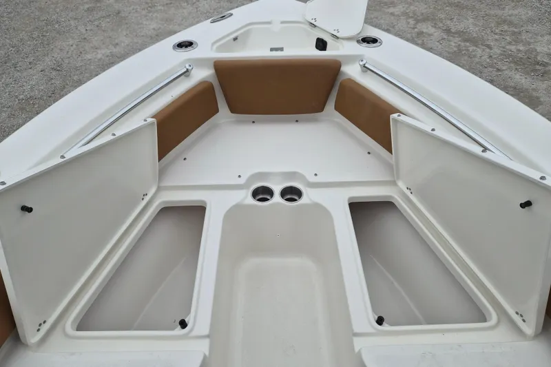 Slide: The Image of 2026 Key West 219 FS boat interior with open storage compartments and cup holders. - 15