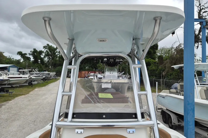 Slide: The Image of 2026 Key West 219 FS boat with T-top and ladder, parked outdoors. - 17