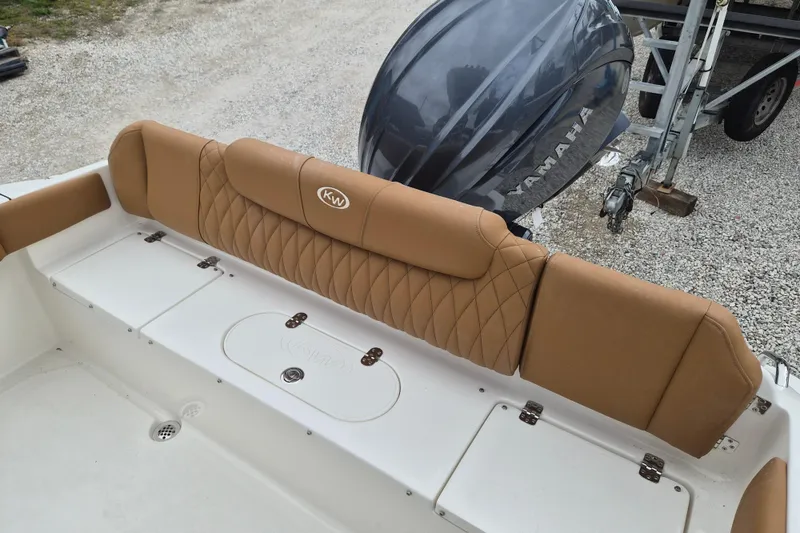 Slide: The Image of 2026 Key West 219 FS boat with tan seating and Yamaha engine. - 5