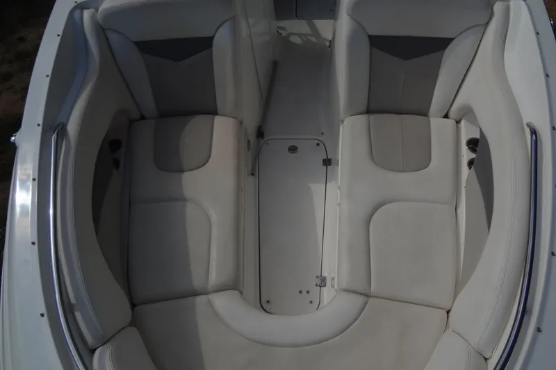 Slide: The Image of 2008 Chaparral 276 SSX boat interior with white cushioned seating. - 14