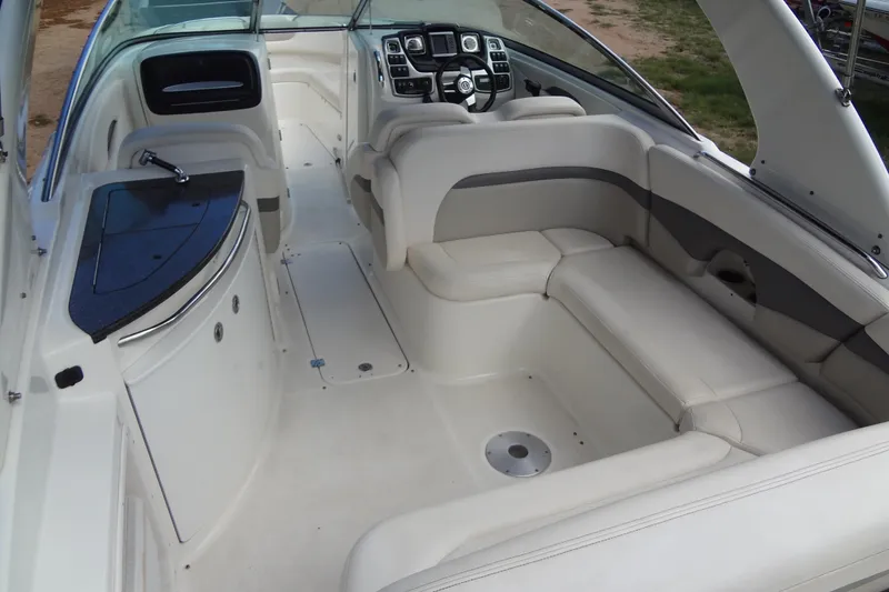 Slide: The Image of 2008 Chaparral 276 SSX boat interior with white seating and sleek dashboard design. - 18