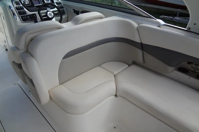 Slide: The Image of Interior seating of a 2008 Chaparral 276 SSX boat, featuring plush white upholstery. - 21