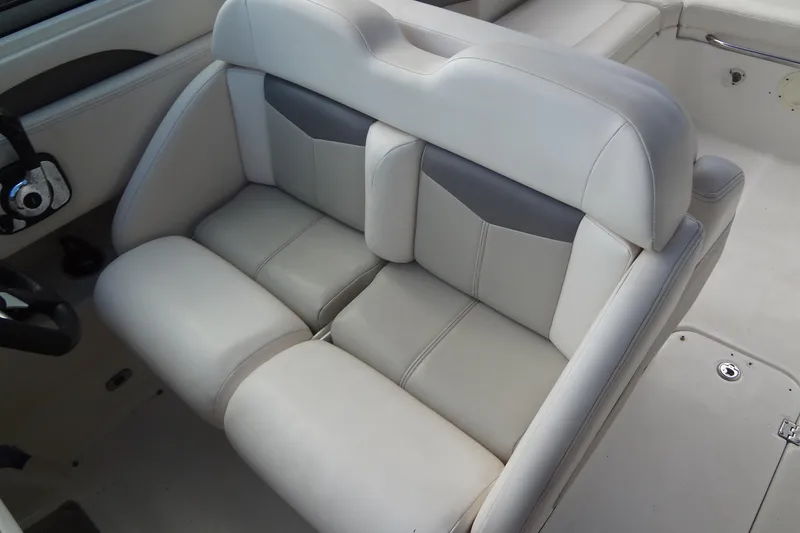 Slide: The Image of 2008 Chaparral 276 SSX boat interior seating, featuring plush, light-colored upholstery. - 24